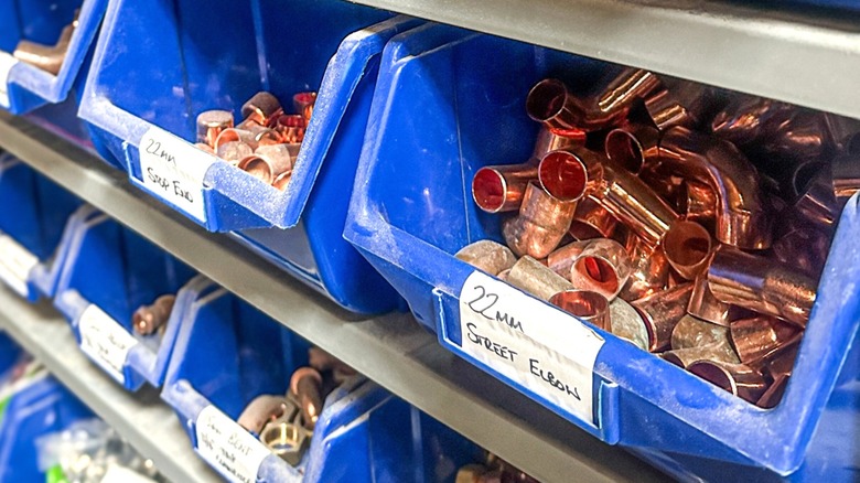 spare copper fittings organized in work shop bins