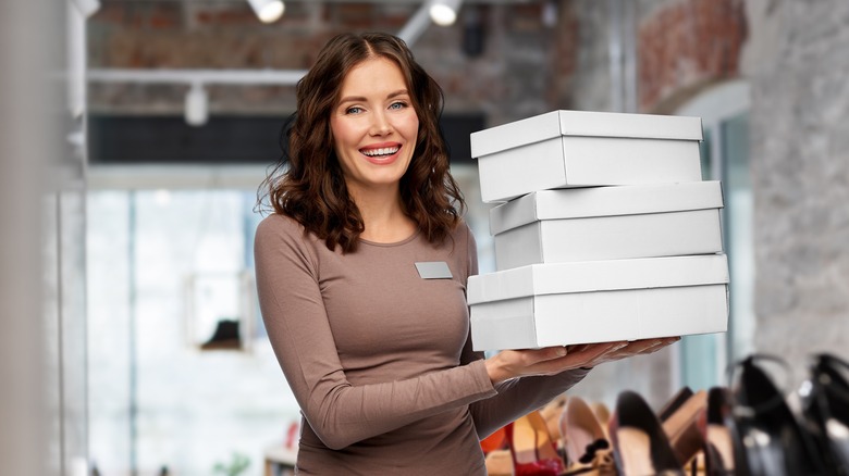 woman holding shoeboxes