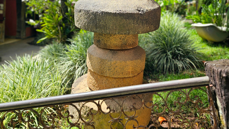 old millstones stacked in a garden