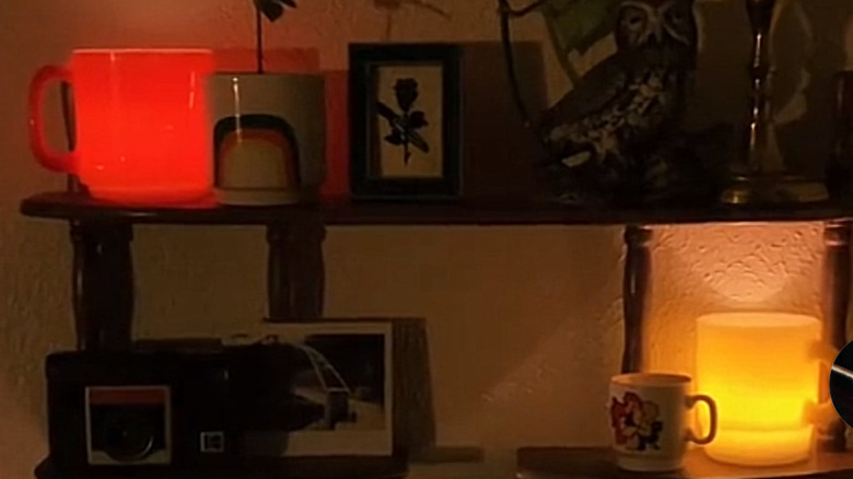 Two mugs with faux tea lights glowing inside