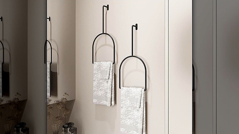 Two Wita towel racks with towels and washcloths on them