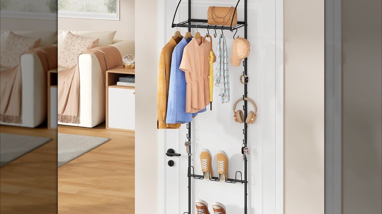 Tajsoon over the door organizer from Amazon with clothes hanging from it, a purse on top, and shoes on the bottom of the rack