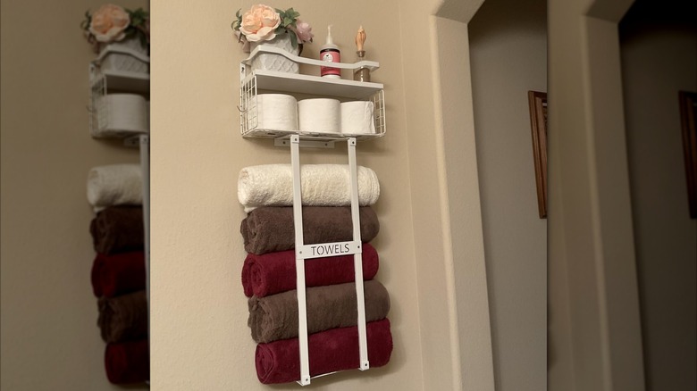 Towel rack in a bathroom with rolled towels