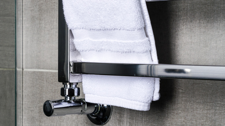 towel rack in a bathroom with a white towel on it