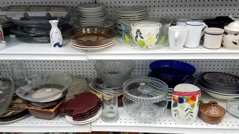 Glassware and ceramics on thrift store shelf