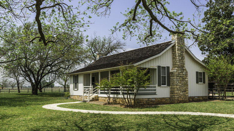 an old historic home surrounded by large trees