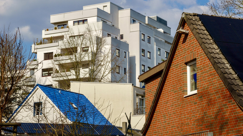 Traditional brick houses and modern high-rise in a residential area