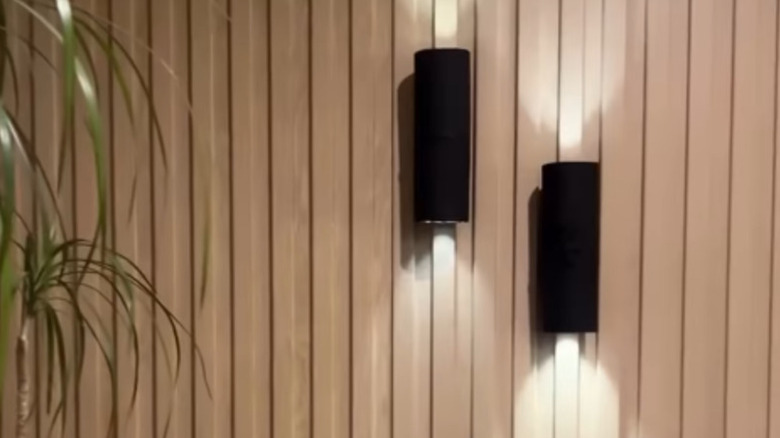 Pringles can wall sconces against a paneled wall