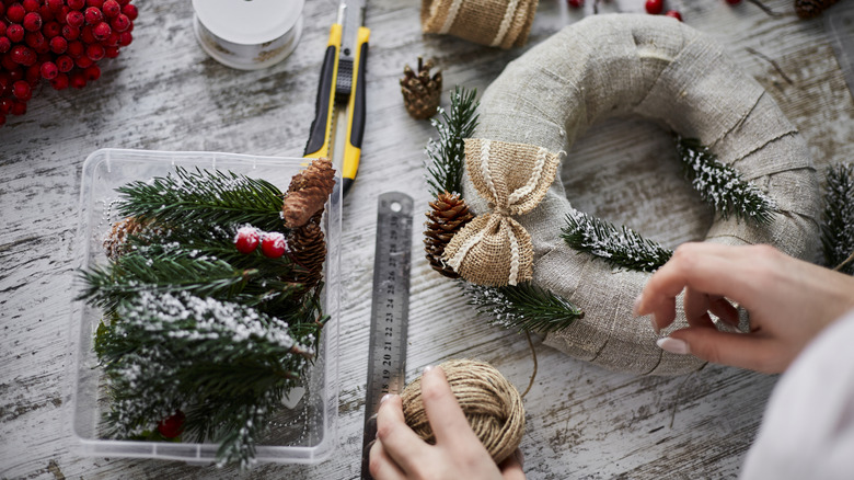 Hands putting together a wreath