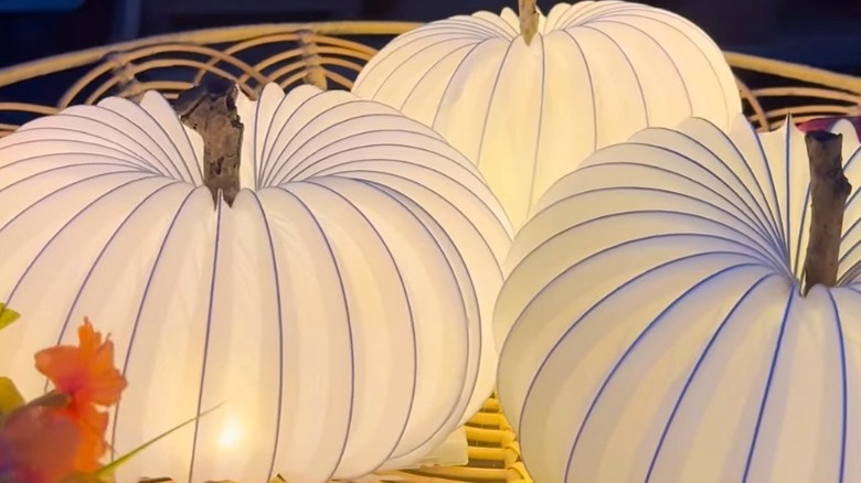 DIY pumpkins made from vinyl dryer vent and twinkle lights
