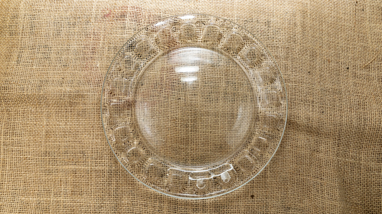 A glass platter on a linen tablecloth