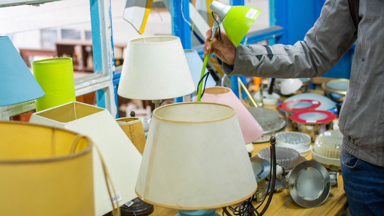 A person shops for lamps at a thrift store