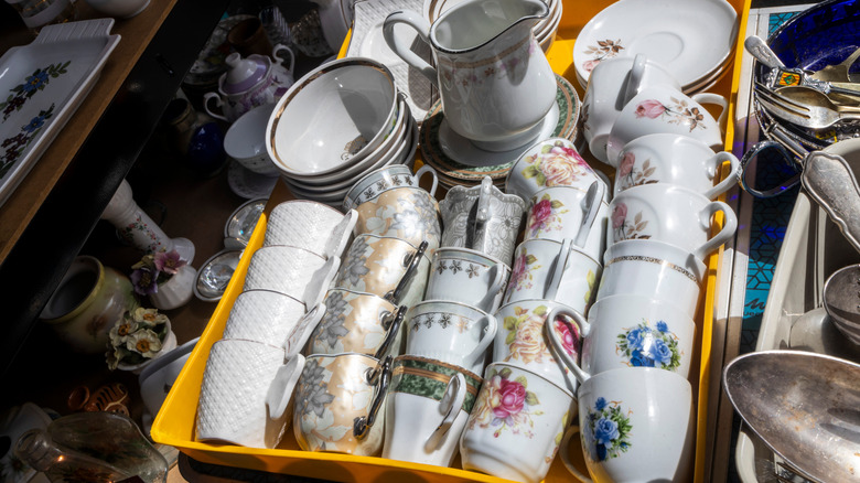 Box filled with teacups and saucers