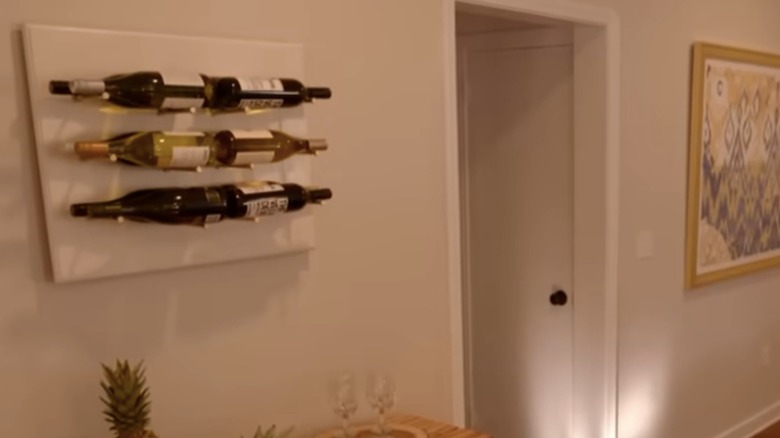 DIY wine rack hanging on kitchen wall