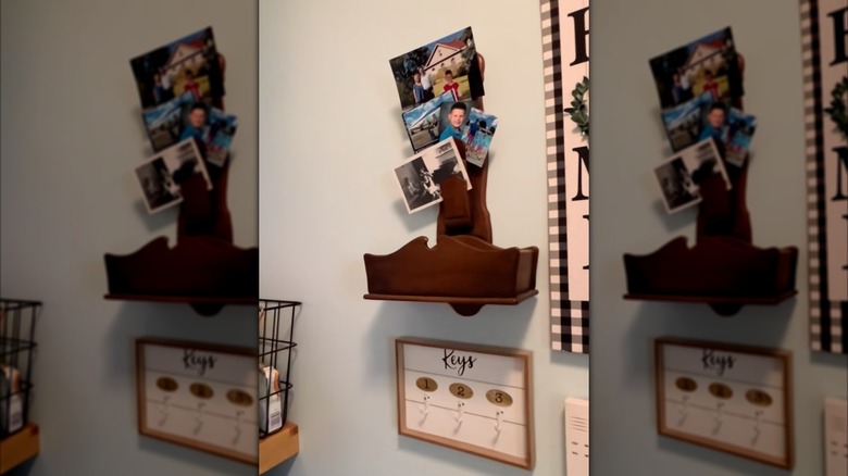 Old letter sorter with photos on a laundry room wall