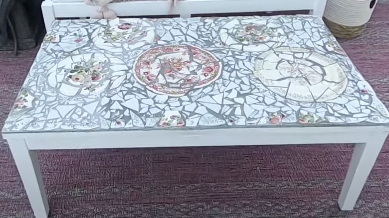A DIYer used broken plates as tile to give her outdoor coffee table a makeover.