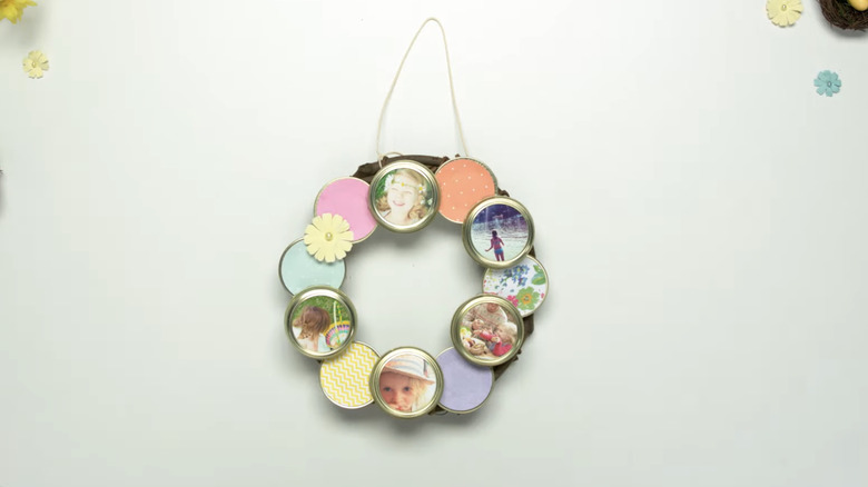 A canning jar lid photo wreath on a white background