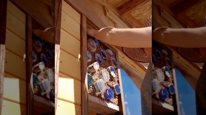 This short video shows the process of building a cob bottle wall.