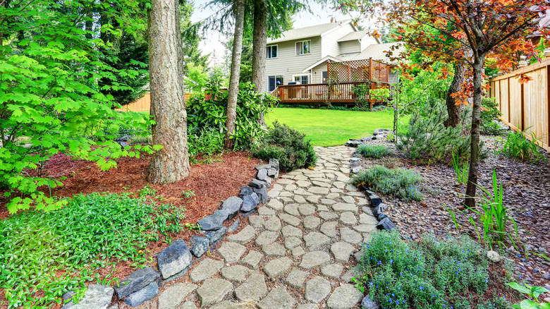 A lovely cobblestone path in a back garden of a house