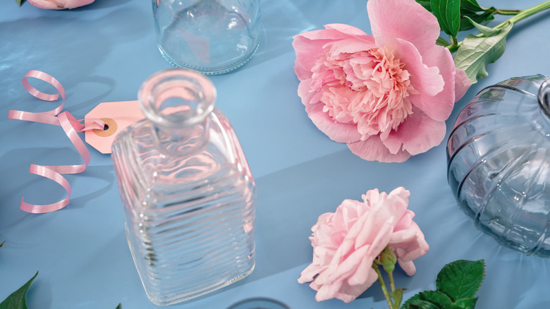 glass bud vases with flowers and tags