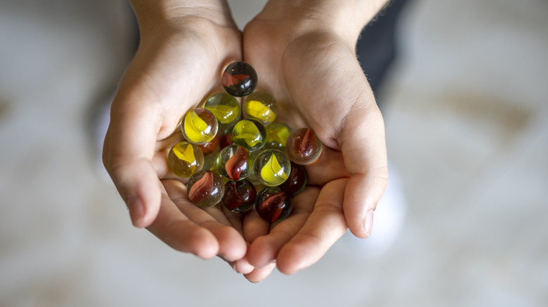 Someone holding glass marbles