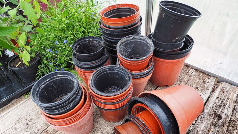 A pile of old plastic plant pots