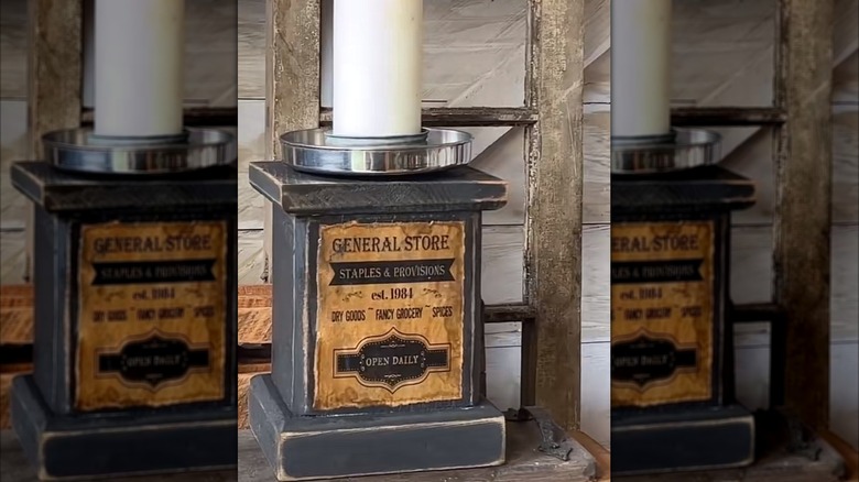 A block of wood and an old metal pot lid turned into a vintage-inspired candle holder.