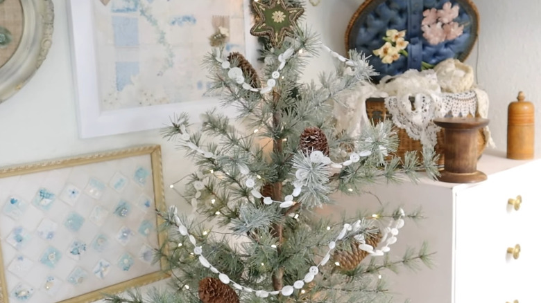 Small Christmas tree with homemade white button garland on it