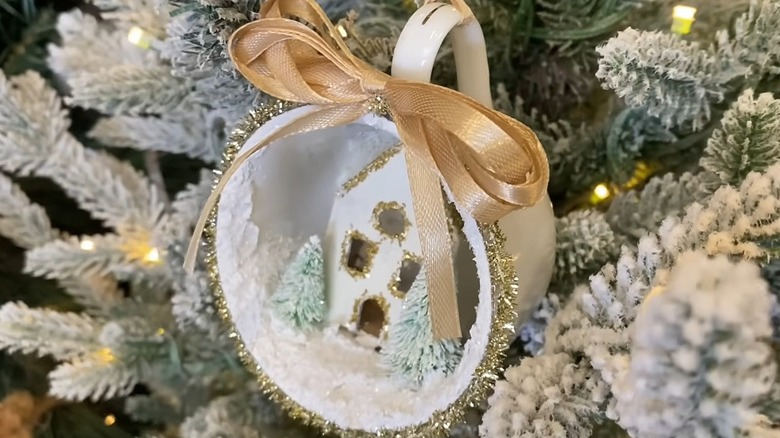 Close-up of a DIY ornament made from a tea cup with a snowy scene inside