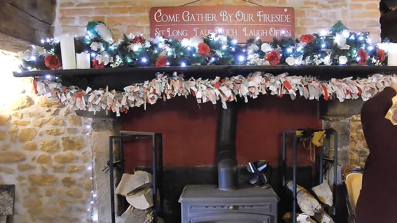 Person hanging a rag-style garland made out of scraps of fabric