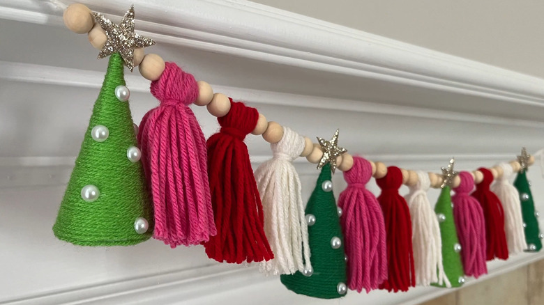 Colorful yarn tassel garland with wood beads and Christmas trees