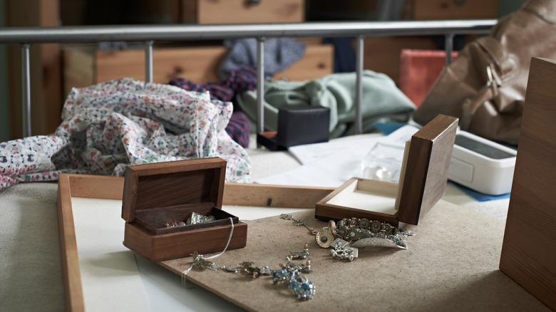 disorganized jewelry boxes in bedroom