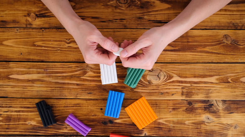 A person uses polymer clay for a crafts project