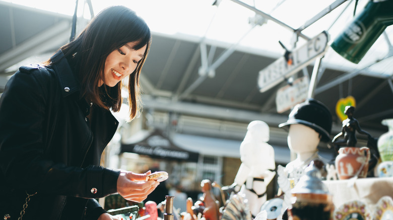 A woman shops at a flea market.