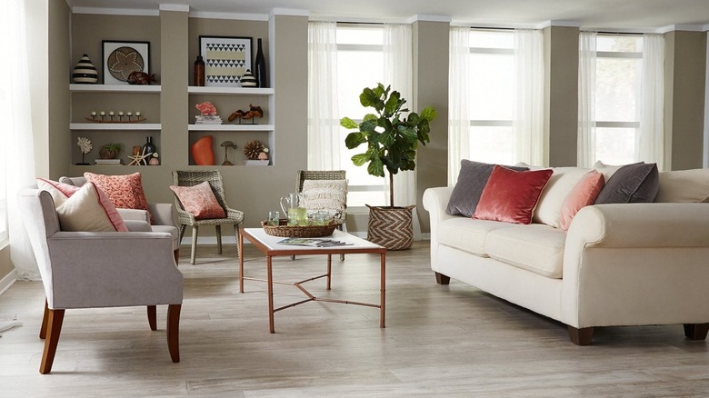 Living room with gray floor, sofa, and statement decor