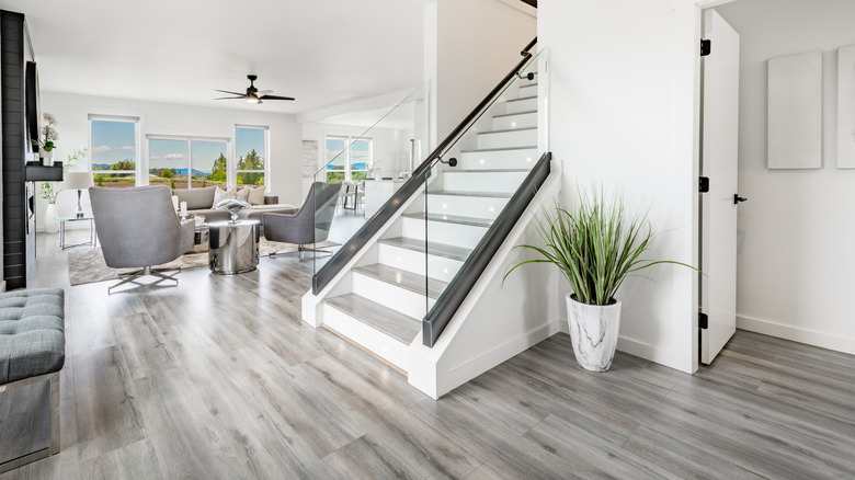 Hallway and living room with gray hardwood floors