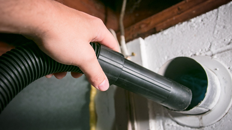 Cleaning a lint vent.
