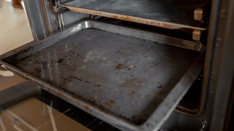 grimy baking sheet in oven