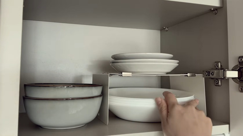 metal bookends form a shelf riser for dishes