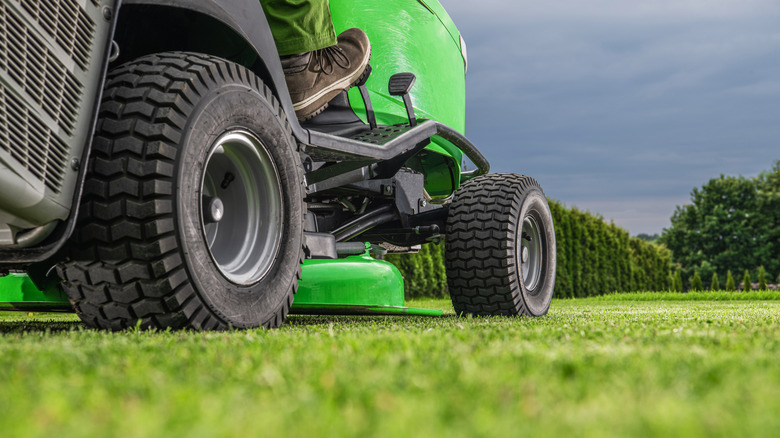 close up of ride on lawn mower on grass.