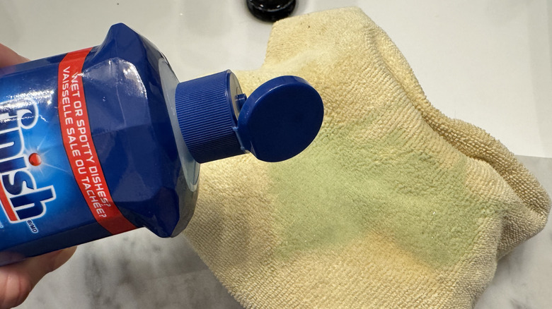 Rinse aid poured onto microfiber cloth