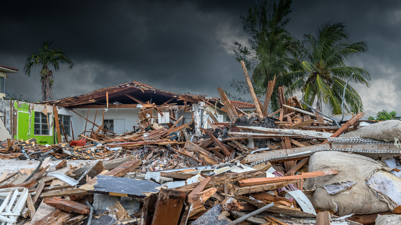 a damaged Florida home amidst debris after a hurricane