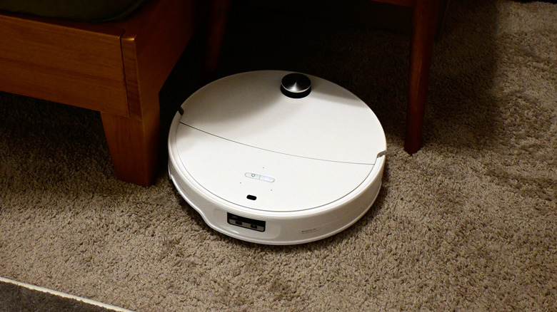 The Roborock Qrevo Edge 3 Pro robot vacuuming medium-pile carpet in a bedroom