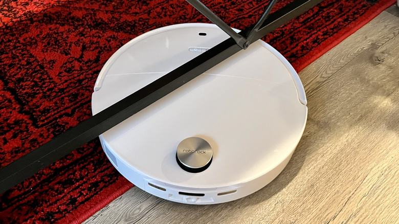 The Roborock Qrevo Edge 3 Pro robot vacuum moving from an area rug onto hard flooring