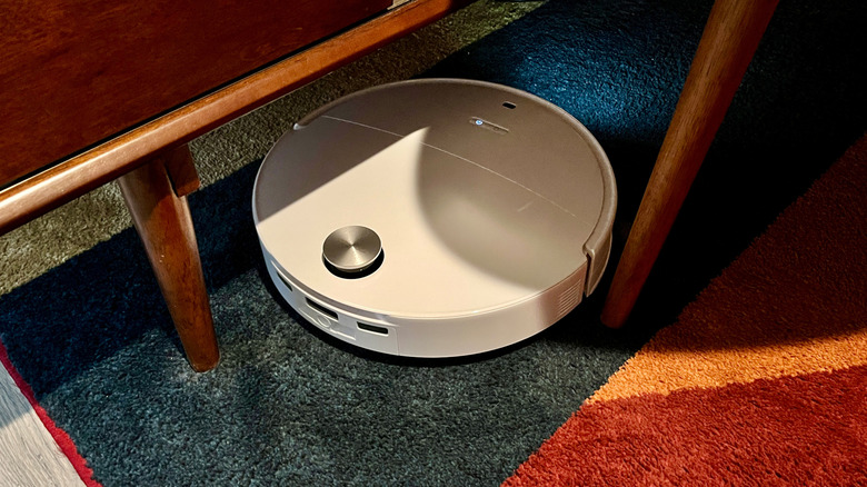 The Roborock Qrevo Edge 3 Pro robot vacuum cleaning on an area rug