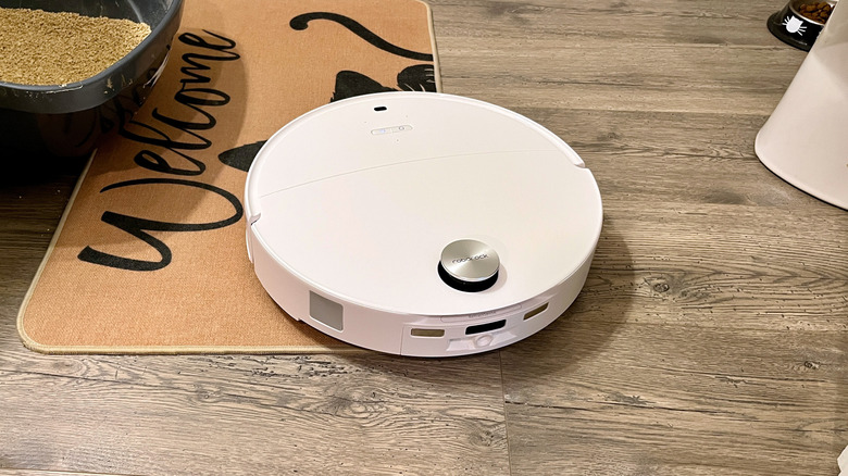 The Roborock Qrevo Edge 3 Pro robot vacuum and mop cleaning around a litter box