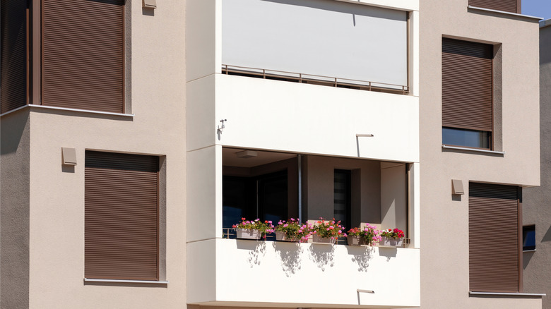 Apartment building with rolling shutters fitted to the windows