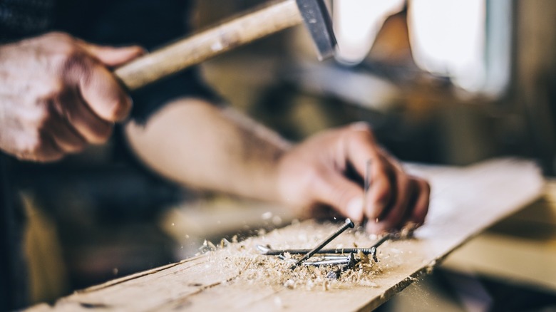 Hammering nails into wood