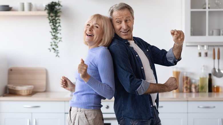 Couple dancing in bright kitchen