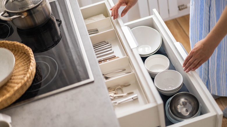 Person opening neat kitchen drawers